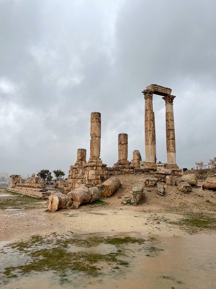 ruins of a fallen Roman temple lay strewn about. Only one pair of columns remains standing.
