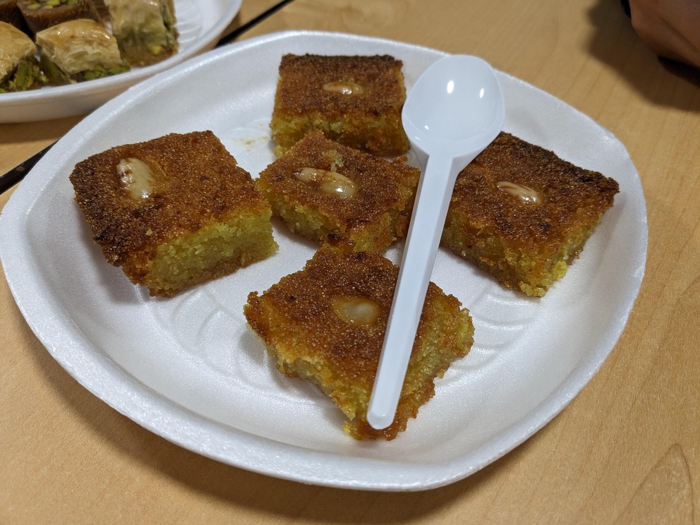 several squares of Jordanian Harissa, a dense semolina cake soaked in rose blossom syrup and topped with an almond