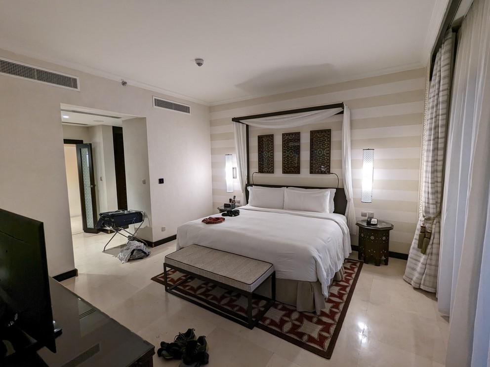 a king-size bed looks small in this extra large marble-floored hotel room with 9-foot ceilings