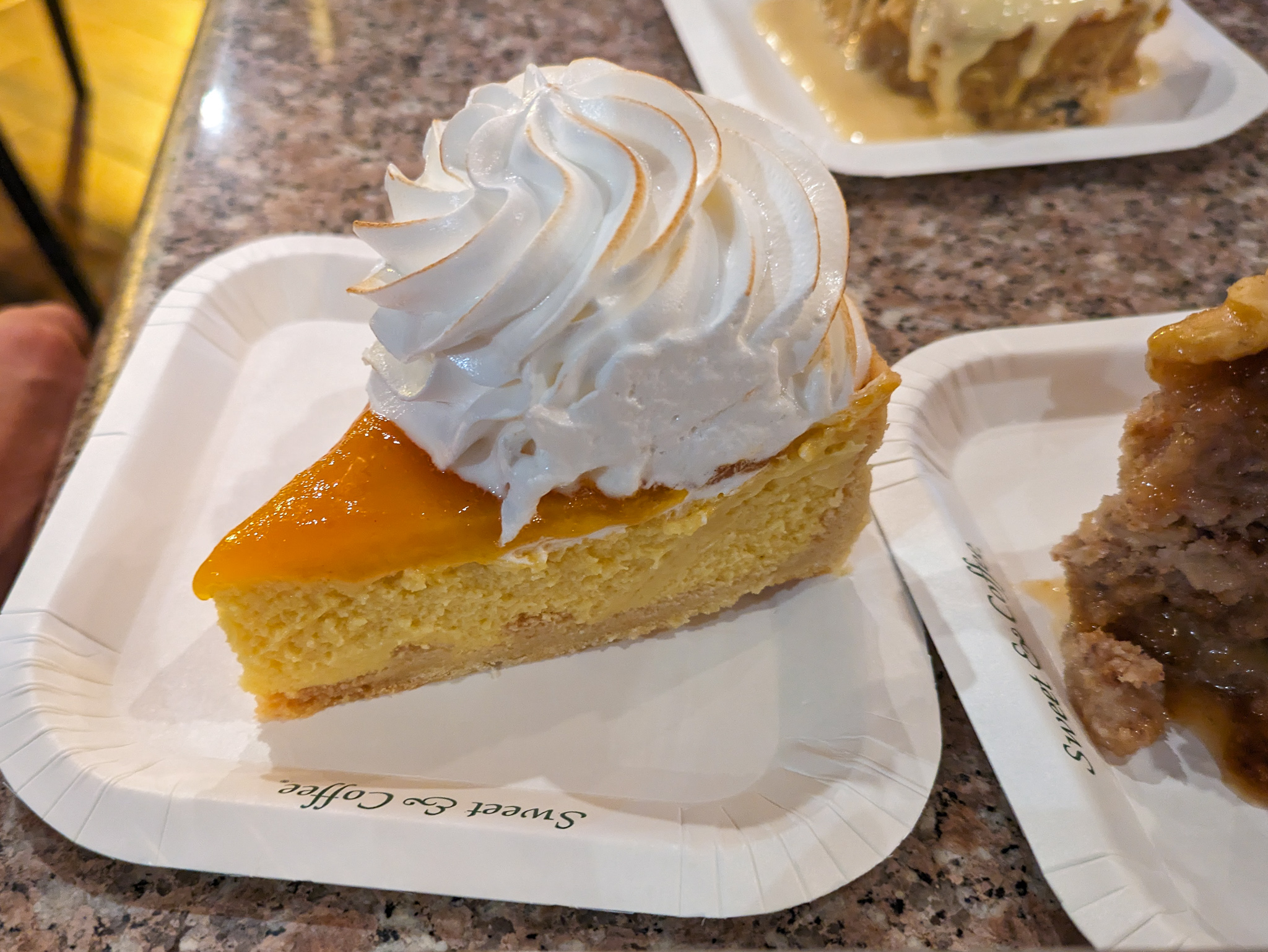 a table with slices of several pies on small plates