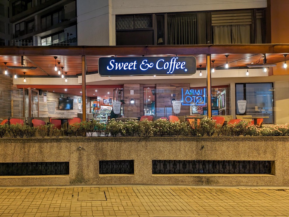 a bakery and coffee shop storefront at night