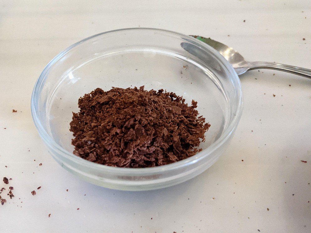 a glass bowl filled with freshly ground cacao paste