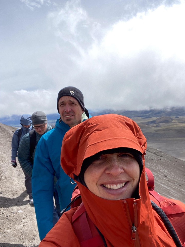 hikers begin their ascent of a volcano by walking through dirt and ash