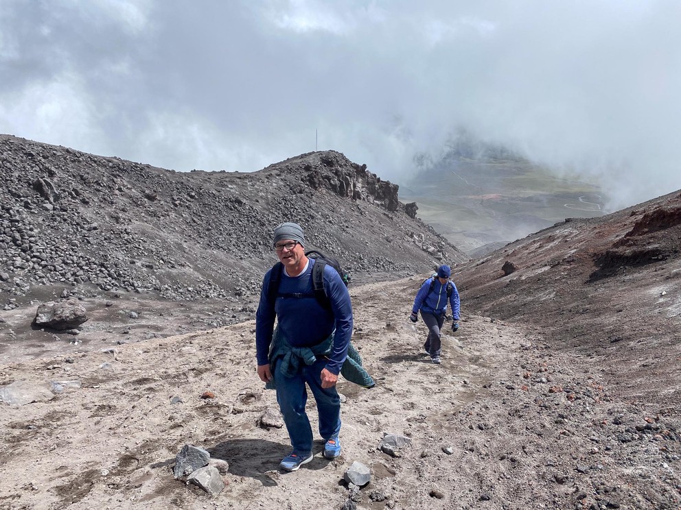two climbers ascend a trough through volcanic ash
