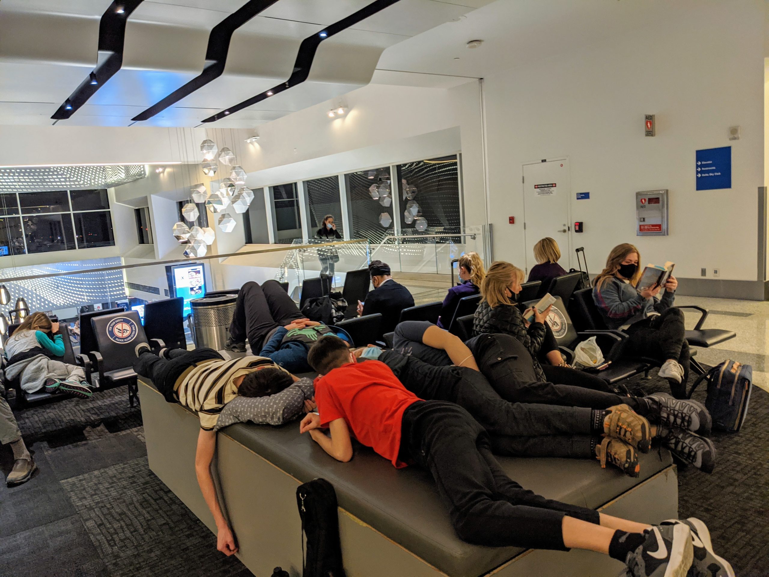 passengers try to sleep through the night in Delta's LAX Terminal 2