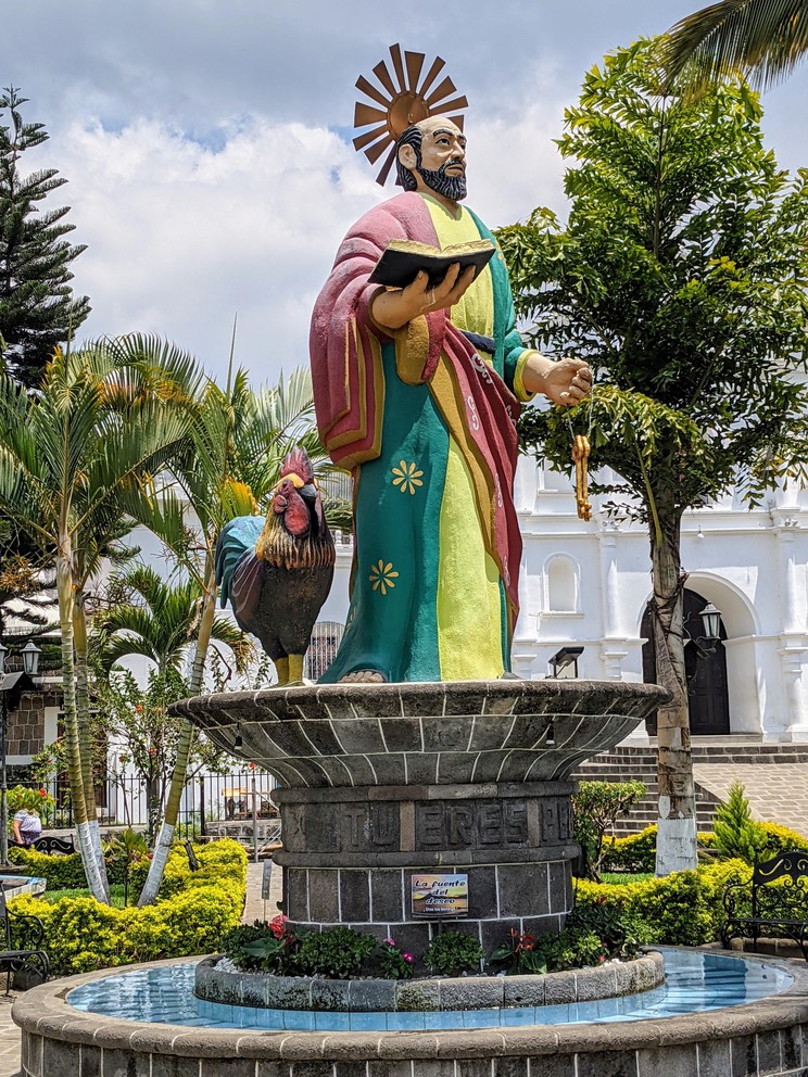 a colorful statue of Saint Peter outside a church in the town of San Pedro La Laguna, Guatemala