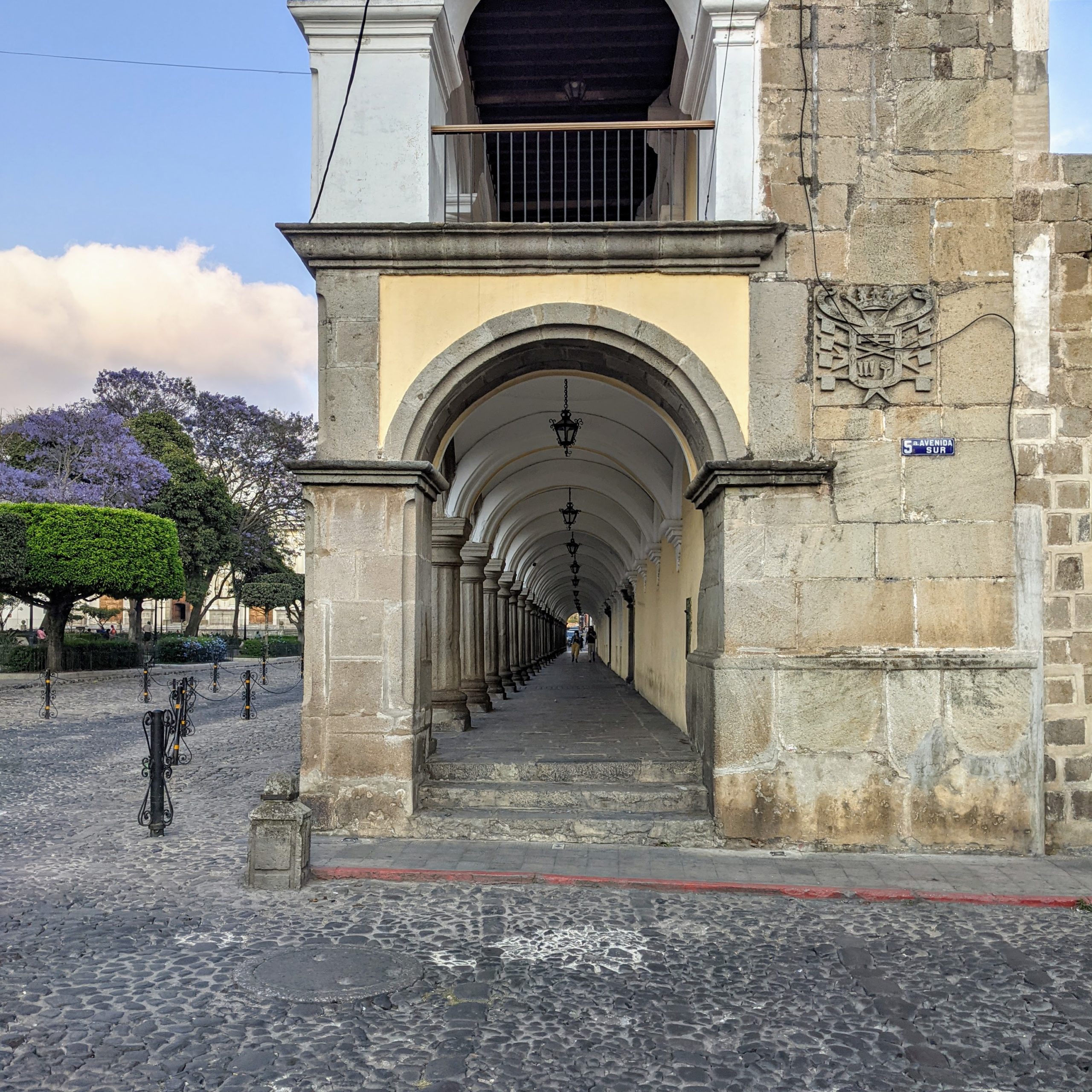 looking down the tunnel created by the colonnaded arcade of the Palacio de los Capitanes Generales on the south side of the Parque Central in Antigua, Guatemala