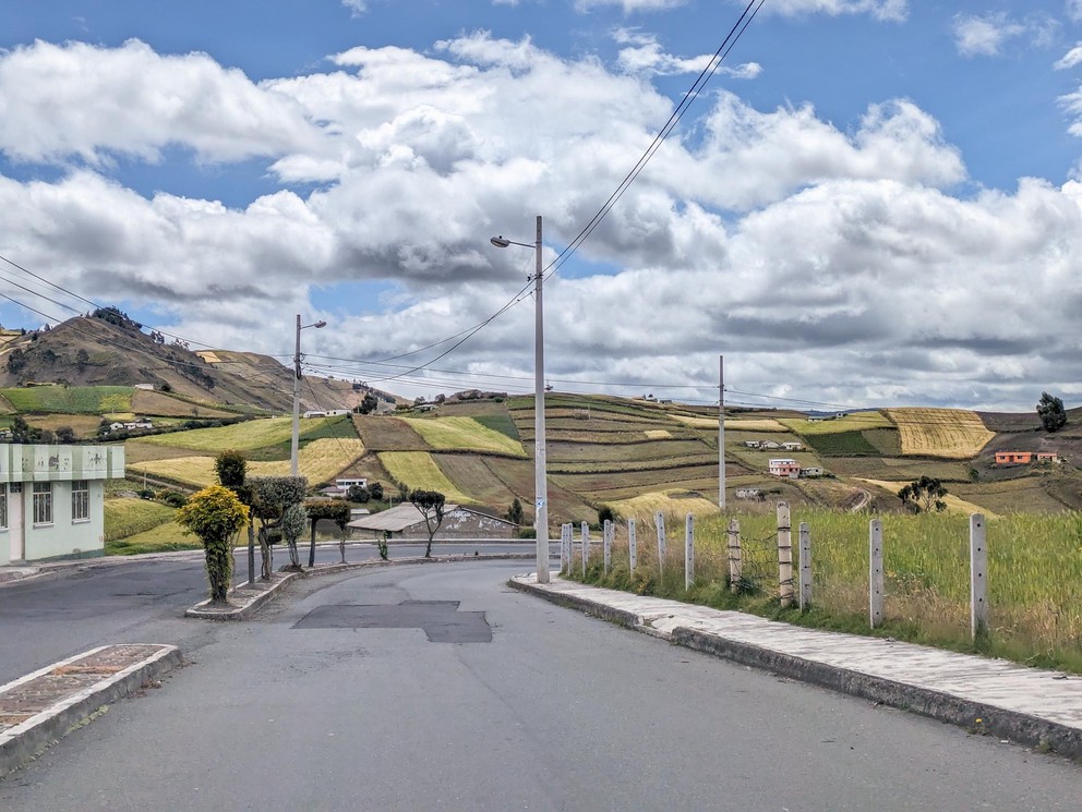 looking down a paved road into the town of Zumbahua, Ecuador