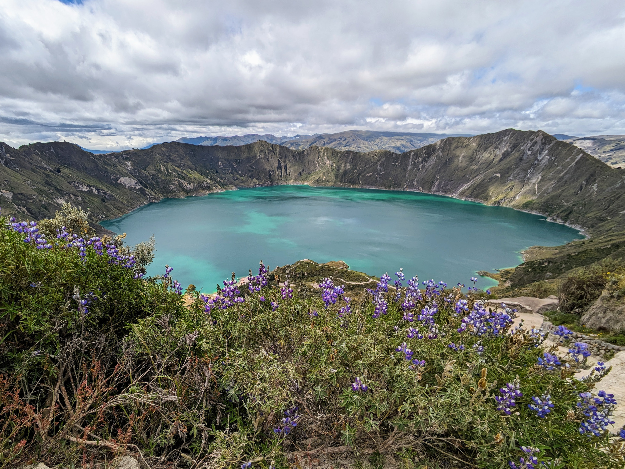 looking down into the crater of an ancient volcano now filled with a turquoise lake