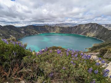 looking down into the crater of an ancient volcano now filled with a turquoise lake