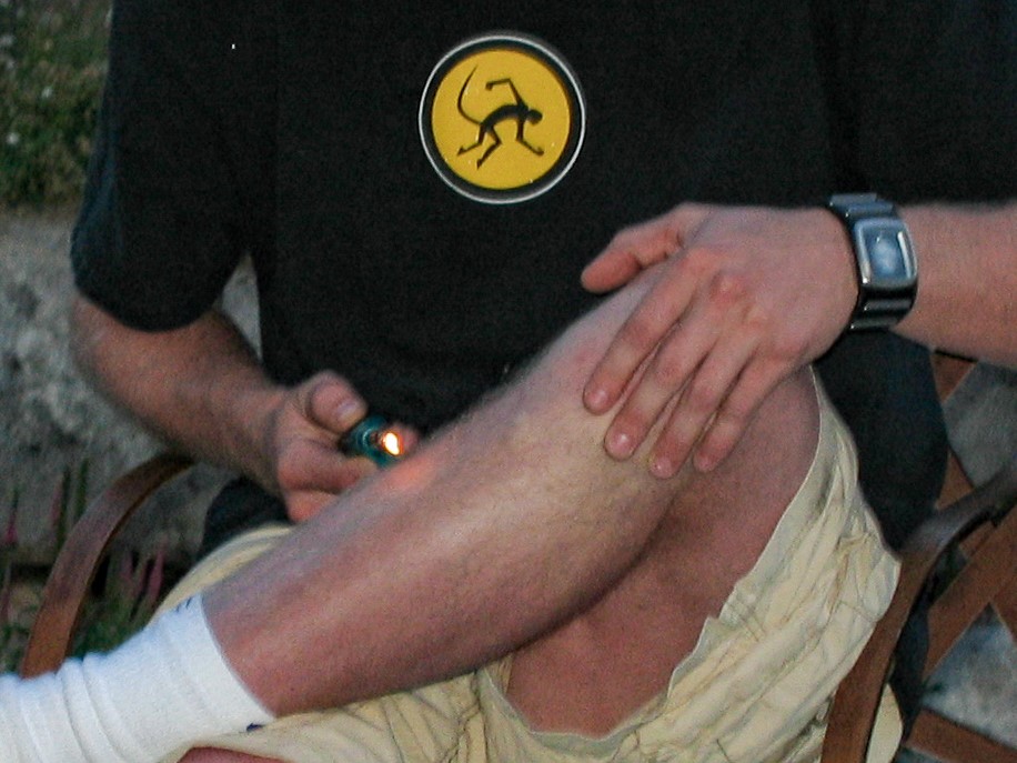 a man attempts to light his leg on fire