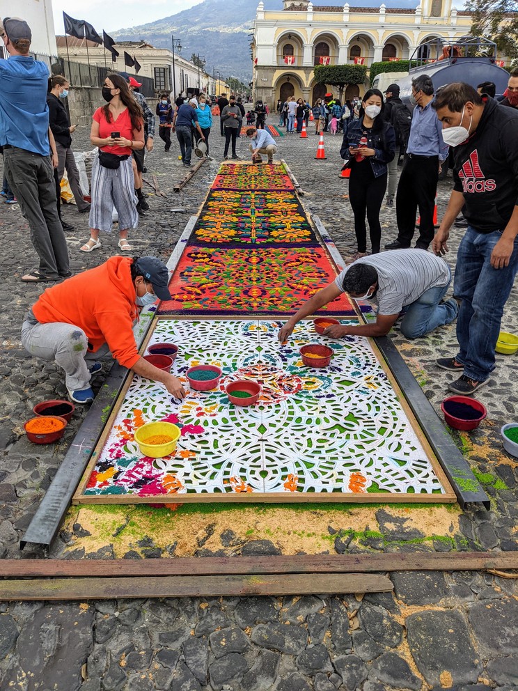 artists put the final touches on a carpet for semana santa in the central plaza of Antigua, Guatemala