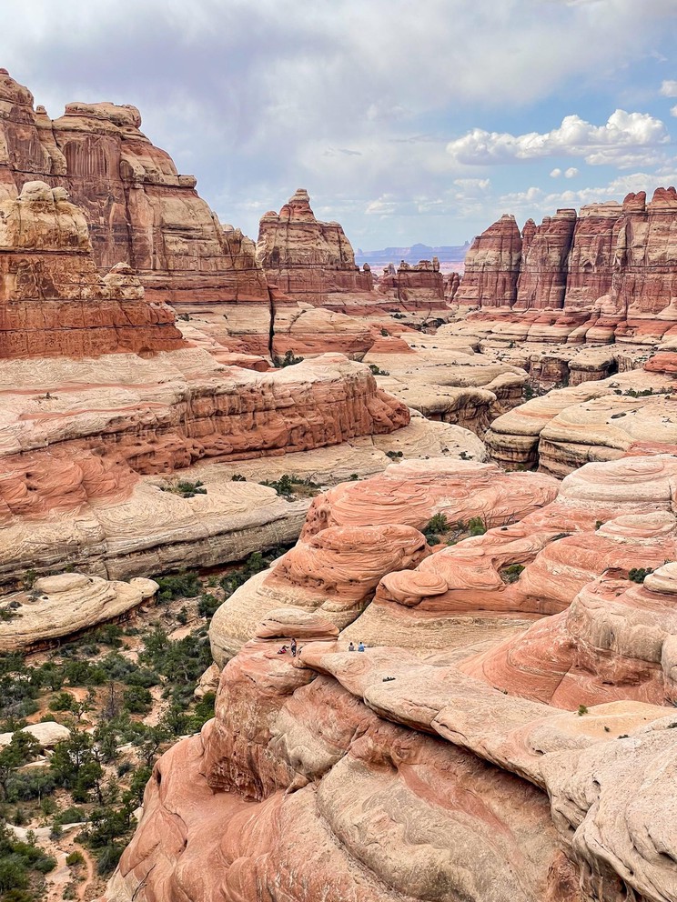 a stunning view of a narrow desert canyon with its towering sandstone walls and huge round sandstone formations known as elephants