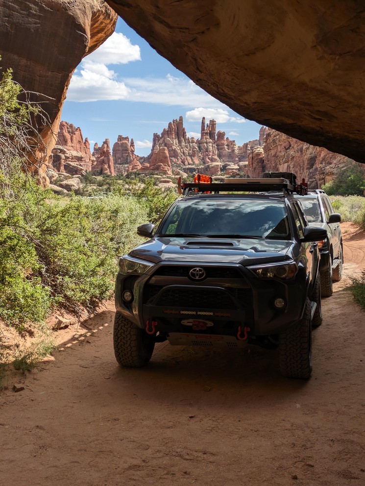 a Toyota 4Runner in a campsite surrounded by huge sandstone spires, cliffs, and other formations