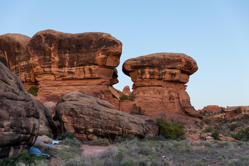 cars nestled in amongst the giant sandstone boulders