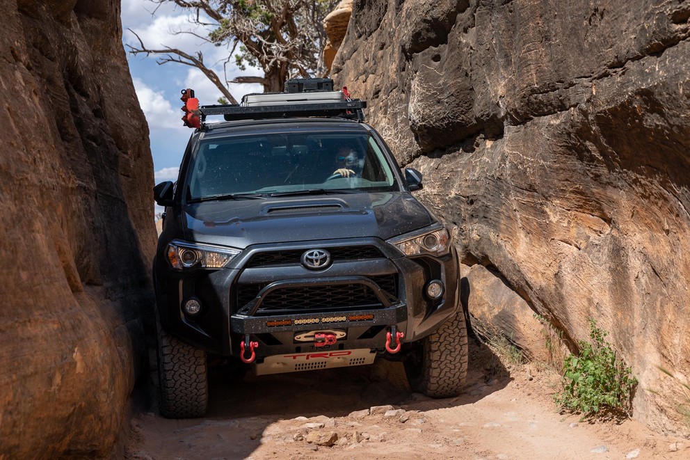 a Toyota 4Runner expertly maneuvers through a tight sandstone squeeze