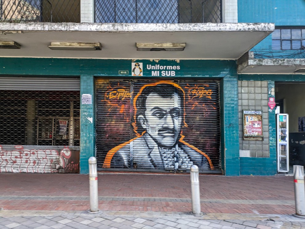 a painting of a man wearing a tuxedo on the garage door to a vendor