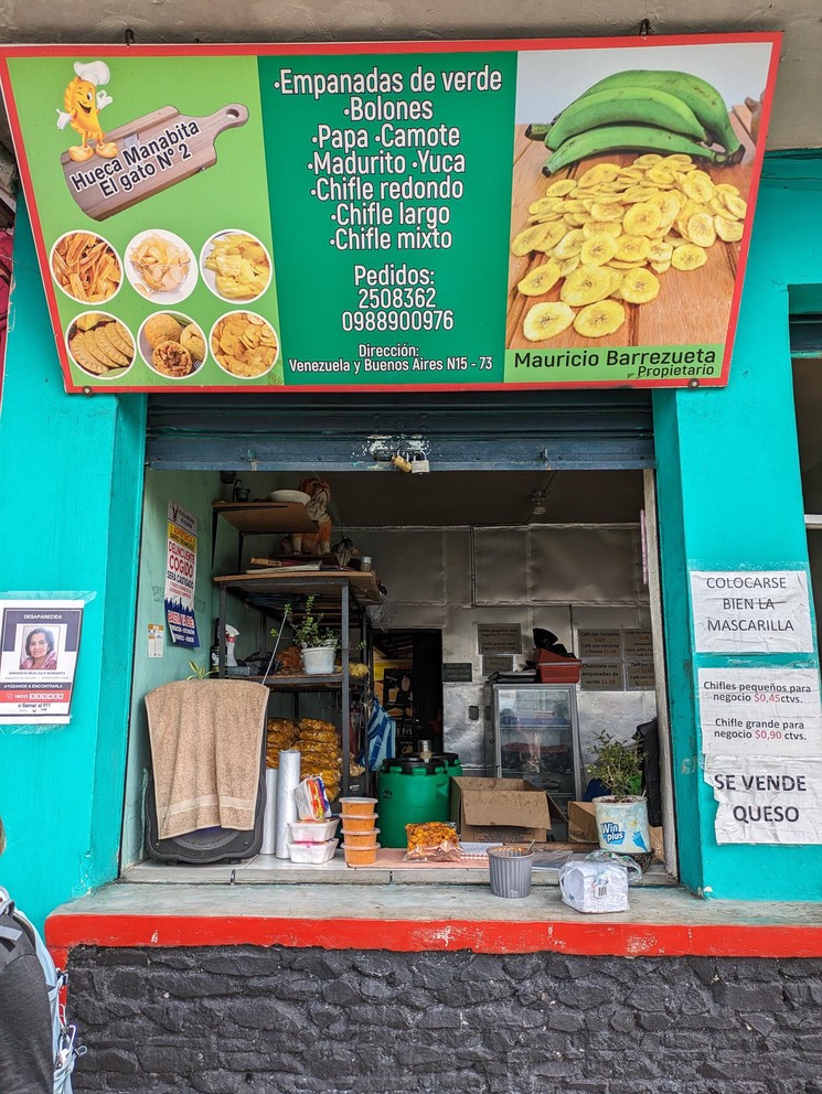 the storefront to a tienda selling green plantain empanandas