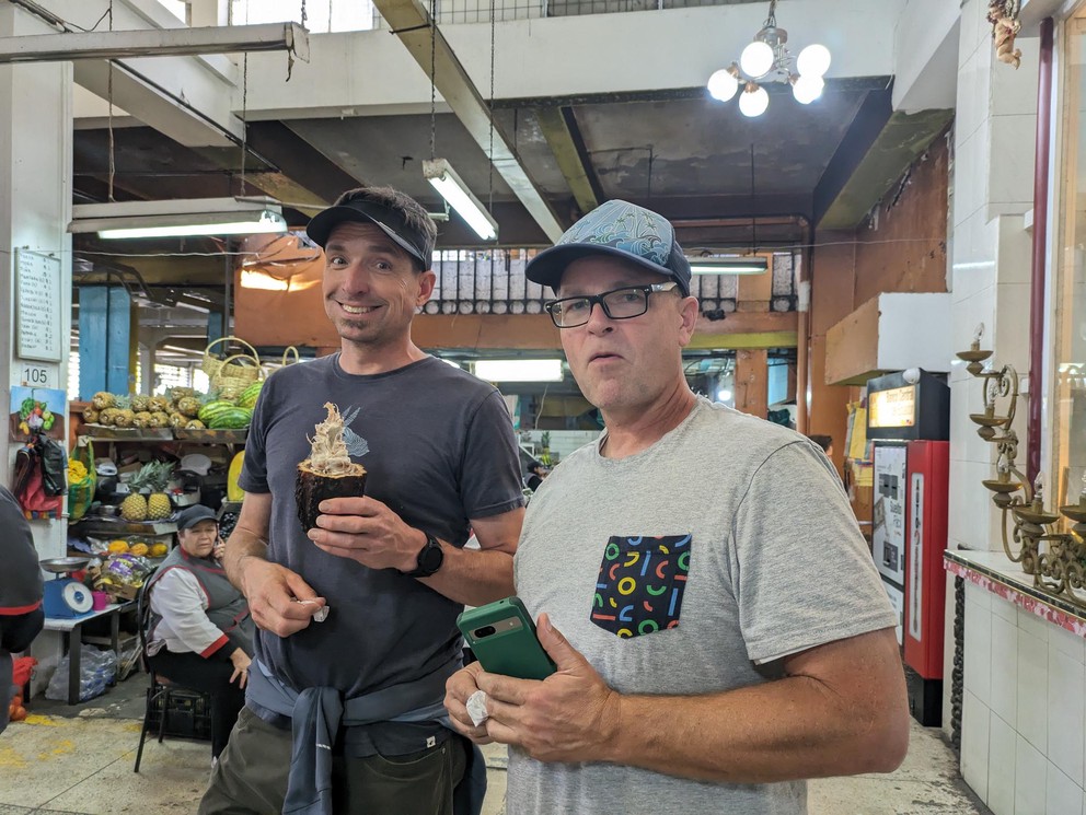 two tourists eat fresh cacao beans