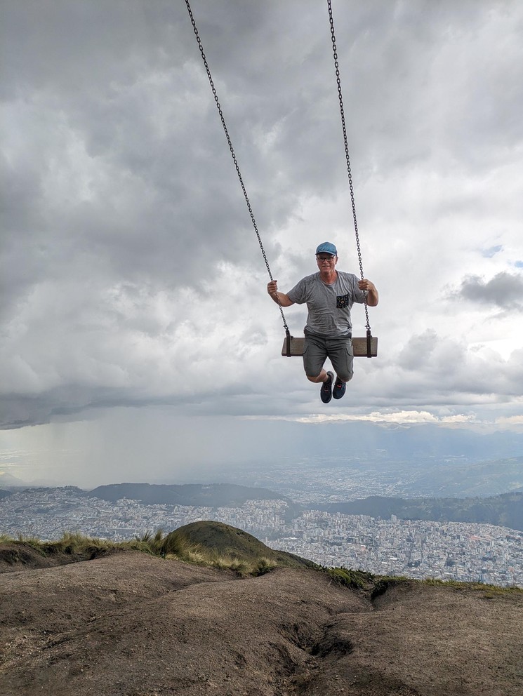 a man flies high on a swing above Quito, Ecuador