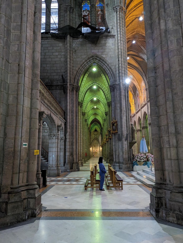 a woman stands near the Nave of the Basilica