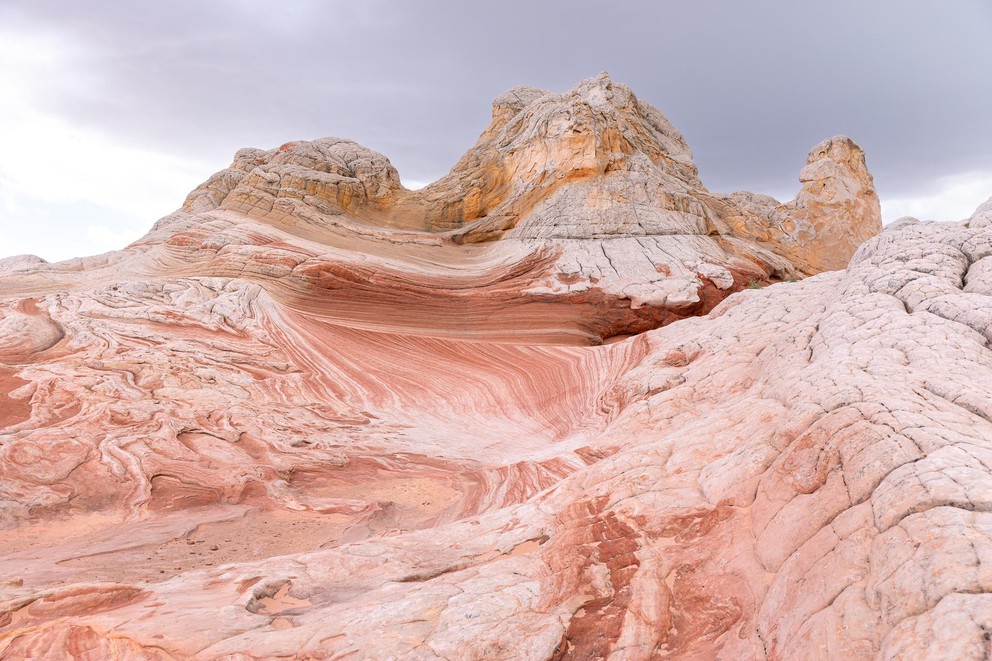 Navajo sandstone formations that look like a few scoops of gold and white ice cream sitting atop melting layers of red and white